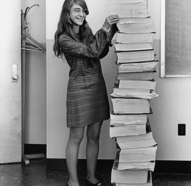 By Adam Cuerden - This is a retouched picture, which means that it has been digitally altered from its original version. Modifications: dust and scratches removed; curves tweaked to bring out shadows, approximately 3 pixels cropped from bottom in order to remove a border. See upload history of the PNG for version without colour tweaks. The original can be viewed here: Margaret Hamilton.gif: ., Public Domain, https://commons.wikimedia.org/w/index.php?curid=59655977